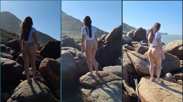 Eva Moderninha, una joven naturista, caminando desnuda por las rocas